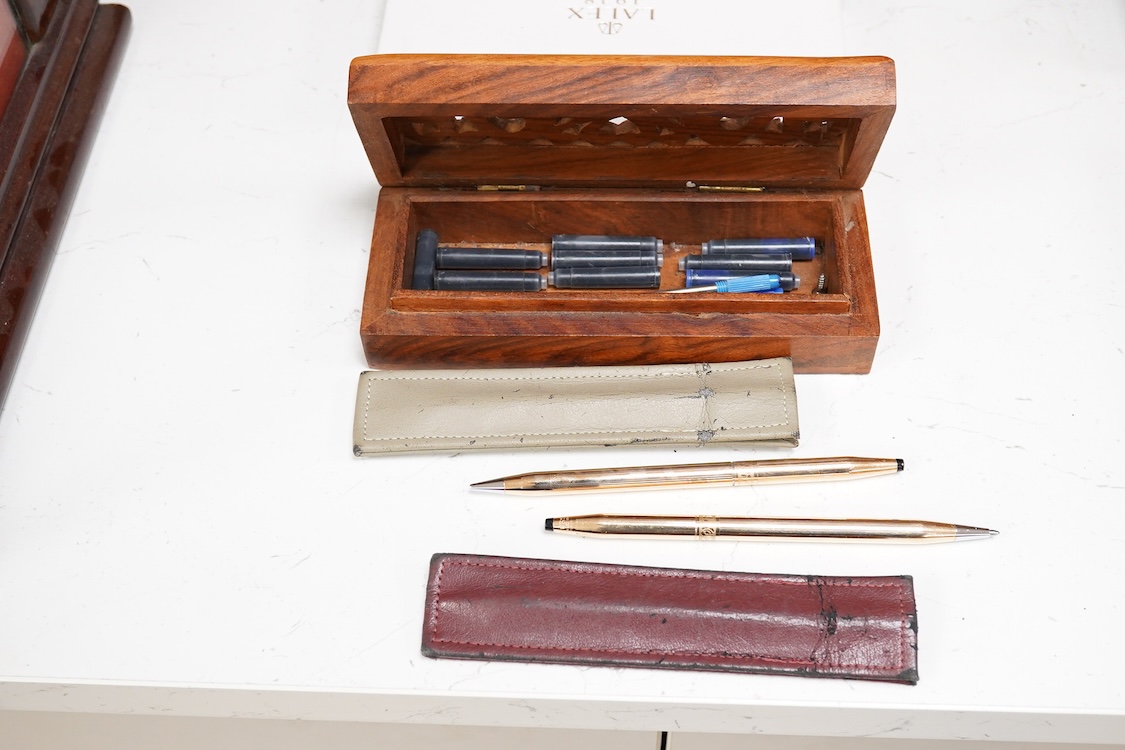 A group of five fountain pens and ballpoint pens